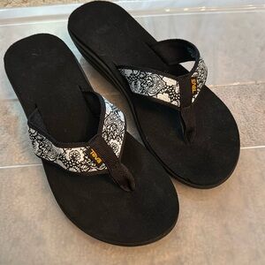 Teva black and silver flip flops